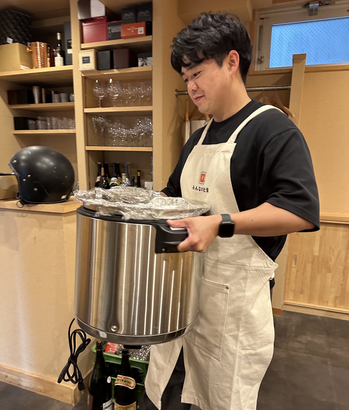 料理の入ったジャーを両手で持つ配送パートナー